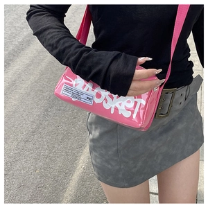 Pink cylindrical crossbody bag featuring white graffiti lettering and woven strap