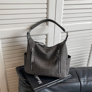 Retro grey woven tote bag with multi-pocket design and wide shoulder strap shown in studio