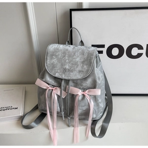 Dettaglio dello zaino in velluto grigio con fiocchi rosa e ricamo NiKa