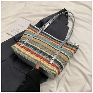 Macro view of woven tote with silver grommet trim and colorful striped texture