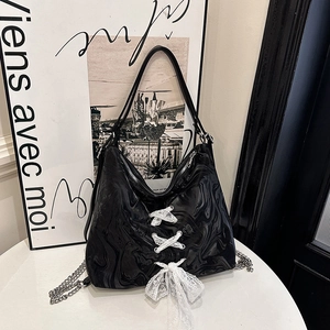 Black marble print tote bag with white corset lace-up detail and silver chain strap