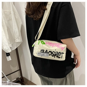 Detail of cream graffiti crossbody bag with adjustable wide strap and logo patch