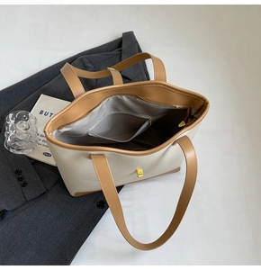 Detail of a large canvas tote bag showing the wide opening with internal zipper pocket