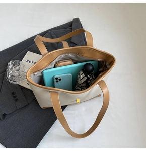 Top view of large cream canvas tote showing interior storage for tablets and essentials