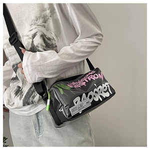 Detail of black glossy graffiti crossbody bag with adjustable wide nylon shoulder strap