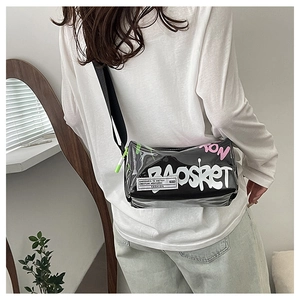 Detail of trendy black graffiti crossbody bag with bold white lettering and green zipper