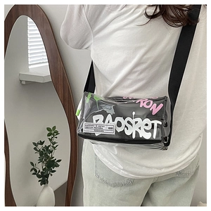 Detail of transparent black PVC crossbody bag with graffiti lettering and adjustable strap