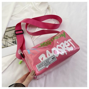 Detail of hot pink graffiti jelly bag with wide shoulder strap and neon logo print