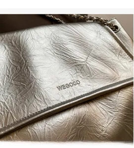 Detail of silver metallic wrinkled leather shoulder bag with chain strap and WEGOCO logo