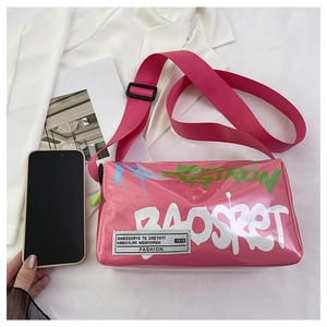 Pink jelly bag with BAOSKET graffiti and adjustable strap next to a smartphone