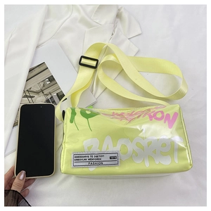 Detail of neon green jelly crossbody bag with wide strap and fashion lettering