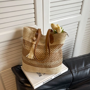 Large capacity woven straw tote bag with brown leather straps and chic tassel charm