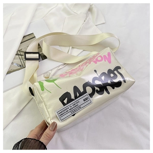 Detail of cylindrical graffiti crossbody bag with BAOSHOT lettering and wide shoulder strap