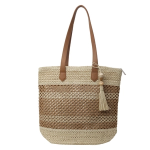 Straw tote bag with striped texture, brown leather handles, and wooden bead tassel