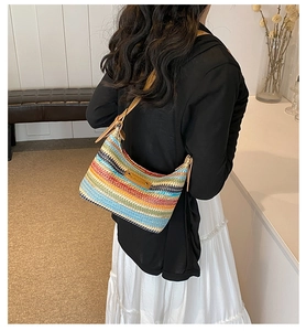 Vue détaillée du dos d'un sac à bandoulière tressé arc-en-ciel avec sangle réglable en cuir