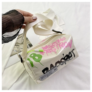 Detail of trendy creamy white jelly crossbody bag with colorful graffiti and fabric strap