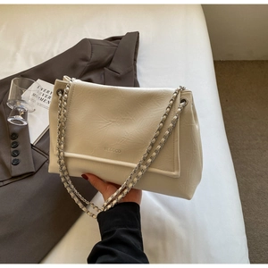 Detail of cream pleated shoulder bag featuring a silver chain and embossed logo
