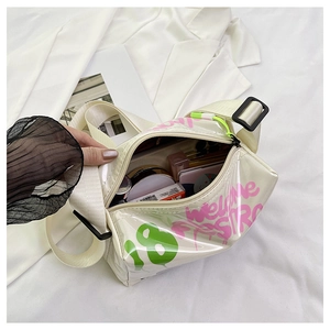 Detailed interior of a white jelly crossbody bag showing space for cosmetics and straps