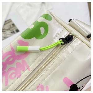 Macro shot of colorful graffiti print with neon green zipper pull on a white jelly bag
