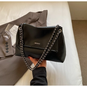 Detail of black pleated leather tote bag with silver chain strap and WEGOCO logo