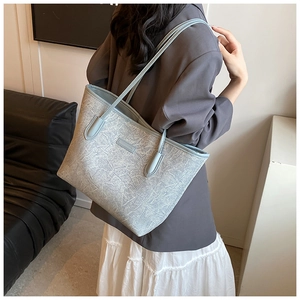 Detailed side view of textured grey-blue tote bag showing large capacity and dual straps