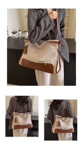 Detail of canvas tote bag with brown leather trim, tassel charm, and multi-way straps
