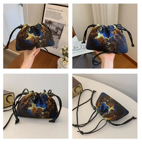 Detail view of abstract oil painting style bucket bag with drawstring and adjustable strap