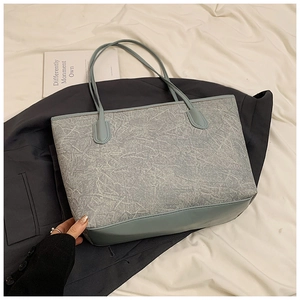 Detailed macro view showing the unique cracked leather texture of this grey tote bag