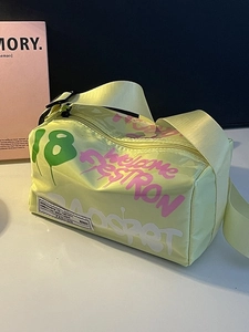 Street style yellow graffiti jelly bag with wide shoulder strap and colorful spray paint
