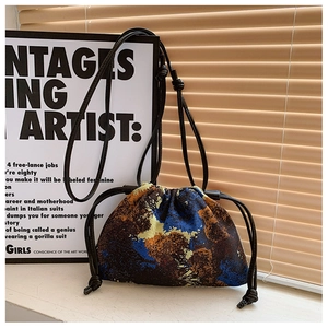 Detail of oil painting style canvas bucket bag with drawstrings and woven rope handle