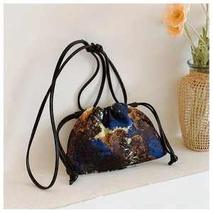 Detailed shot of an abstract oil painting pattern bucket bag with drawstring closure