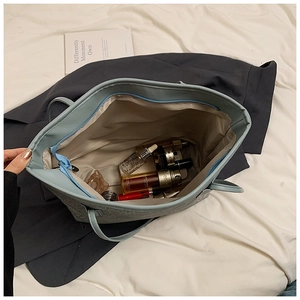 Top view of large light blue tote bag interior showing spacious capacity and zipper closure