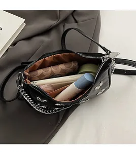 Top view of the black leather bag interior showing ample space and silver chain strap