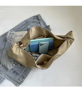 Top view of large khaki messenger bag showing spacious interior with daily essentials