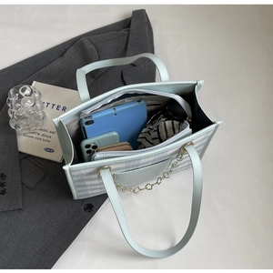 Top view of large capacity tote bag showing spacious interior with tablet and phone