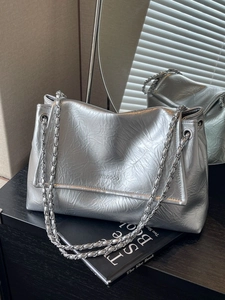 Silver wrinkled leather tote bag with metallic chain strap for women commuters