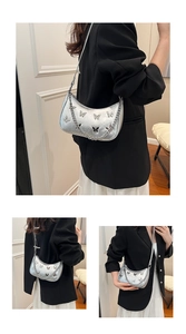 Detail of silver hobo bag featuring 3D butterfly patterns and metallic chain strap