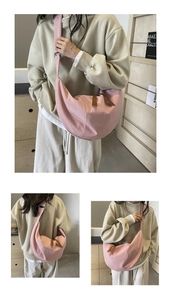 Detail view of pink canvas crescent bag showing front and back on-body styling