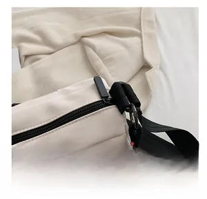 Détail de la fermeture éclair noire et de la corde tressée sur le sac cabas en toile écrue