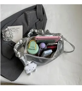 Spacious interior of silver metallic tote bag showing tablet, water bottle and umbrella