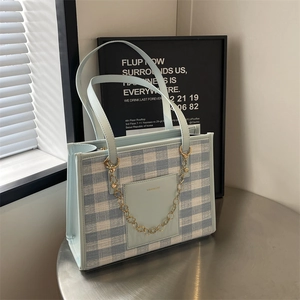 Chic blue and white checkered tote bag with gold chain strap for stylish daily commuting