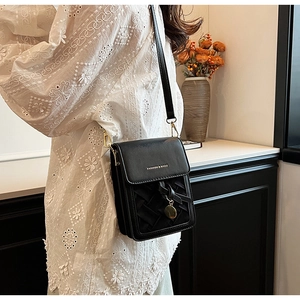 Detail of black leather phone bag with woven pattern and Fashion & Bags metal logo charm