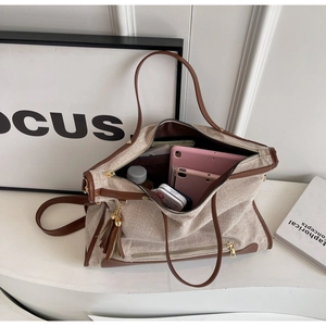 Macro view of canvas tote bag interior showing large capacity for tablet and essentials