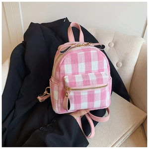 Detailed close-up of pink gingham mini backpack with gold hardware and bow detail