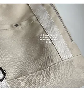Close-up of beige canvas tote fabric texture with reinforced rivets and zipper detail