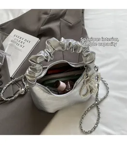 Detail showing the large interior capacity of this silver metallic pleated cloud bag