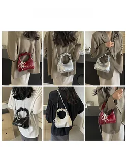 Detailed views of ruched crescent handbag with pearl bow charm in four elegant colors