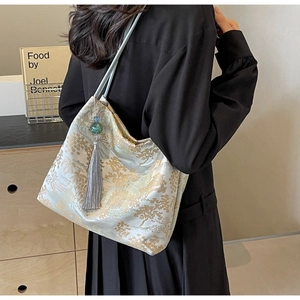 Detail of Chinese style tote bag with gold embroidery and silk tassel charm
