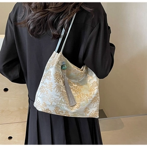 Close-up of golden embroidery and silk tassel on the large Chinese style tote bag
