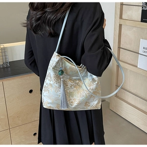 Detail of Chinese style tote bag with mountain embroidery and a jade bead tassel